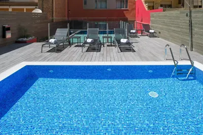 a swimming pool on the roof of a building at Catalonia Sagrada Familia in Barcelona