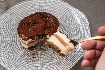 a piece of cake on a plate with a fork at Catalonia Sagrada Familia in Barcelona