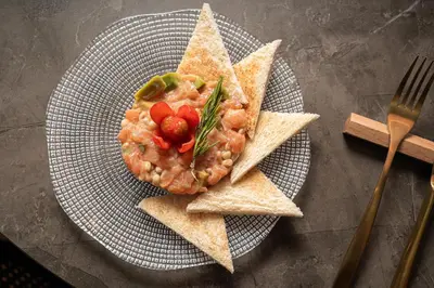 a plate of food with shrimp and pita chips at Catalonia Park Güell in Barcelona