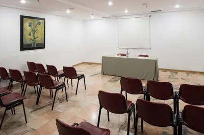 a room with chairs and a table and a podium at Catalonia Albeniz in Barcelona