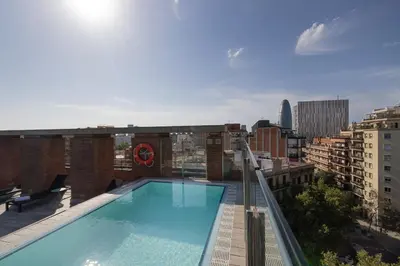 a hotel room with a bed and a couch at Catalonia Albeniz in Barcelona