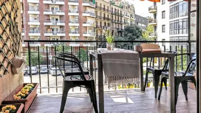 a balcony with a table and chairs on a balcony at Livingstone in Barcelona