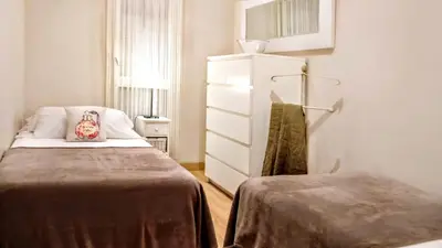 a small room with a bed and a dresser at Livingstone in Barcelona