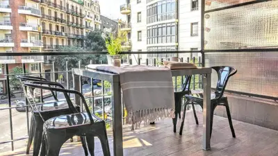 a table and chairs on a balcony with a view of a city at Livingstone in Barcelona