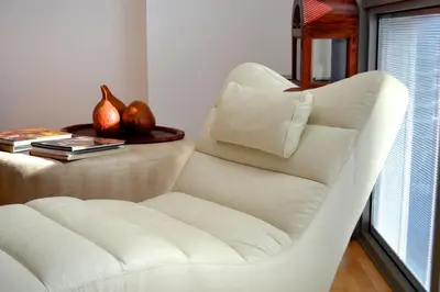 a white chair in a room with a table at Livingstone in Barcelona