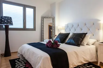 a bedroom with a large bed and a mirror at Livingstone in Barcelona