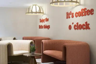 a restaurant with tables and chairs and windows at Catalonia Barcelona 505 in Barcelona