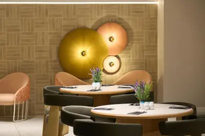 a restaurant with wooden tables and chairs and tablesktop at Catalonia Barcelona 505 in Barcelona