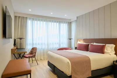 a bedroom with a large white bed with red pillows at Catalonia Barcelona 505 in Barcelona
