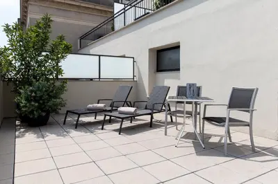 a group of chairs and tables on a patio at Hotel Balmoral in Barcelona