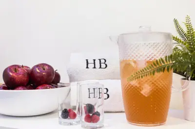 a table with a pitcher of juice and a bowl of fruit at Hotel Balmoral in Barcelona