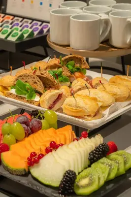 two trays of different types of food on plates at Hotel Balmoral in Barcelona
