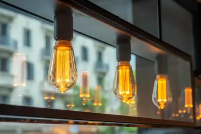 a group of lights hanging from a window at Hotel Balmoral in Barcelona
