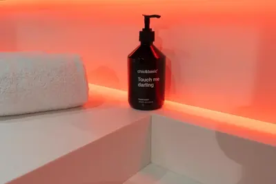 a bottle of mouthwash sitting on a bathroom counter at chic&basic Reding in Barcelona