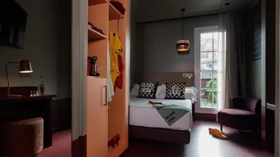a small bedroom with a bed and a window at chic&basic Reding in Barcelona