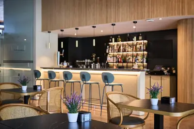 a restaurant with tables and chairs and a bar at Catalonia Sabadell in Sabadell