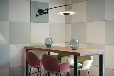 a table with chairs and two wine glasses on it at Catalonia Sabadell in Sabadell