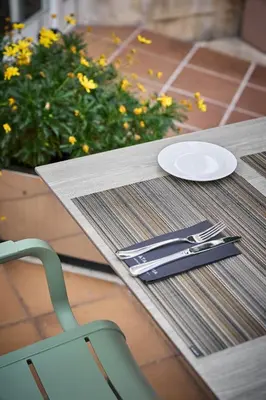 a table with a plate and utensils on it at Catalonia Bristol in Sant Andreu de la Barca