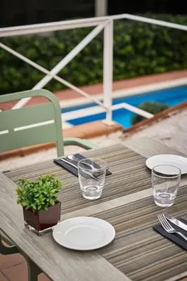 a restaurant with tables and chairs in a room at Catalonia Bristol in Sant Andreu de la Barca