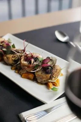 a white plate of food on a table at Duquesa de Cardona Hotel 4 Sup by Grup Duquessa in Barcelona