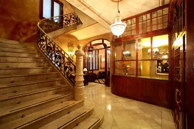 a stairway in a building with a staircase sidx sidx at Hotel Nouvel in Barcelona