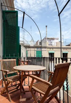 a table and chairs on the roof of a building at Hotel Nouvel in Barcelona