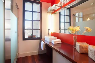 a bathroom with a counter with a sink and a mirror at Beach Loft Duplex in Barcelona