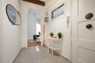 a hallway with a white door and a mirror at Barcelona Just Like Home in Barcelona