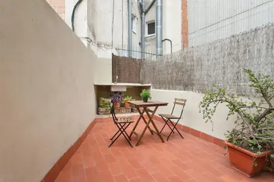 a patio with a table and chairs and plants at Barcelona Just Like Home in Barcelona