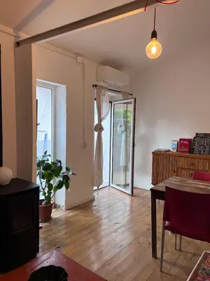 a living room with a table and a glass door at Alojamiento con encanto en planta superior ideal para trabajo y escapadas familiares en Montserrat in Esparreguera