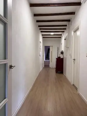 an empty hallway with white walls and wood floors at Alojamiento con encanto en planta superior ideal para trabajo y escapadas familiares en Montserrat in Esparreguera