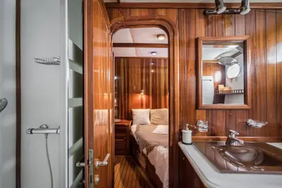 a bathroom with a sink and a mirror and a bed at SPACIOUS YACHT HOTEL BARCELONA CITY CENTER 5 CABINs in Barcelona