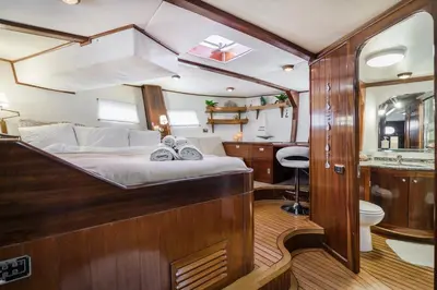 a bedroom in a boat with a bed and a sink at SPACIOUS YACHT HOTEL BARCELONA CITY CENTER 5 CABINs in Barcelona