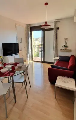 a living room with a red couch and a table at Lovely Appart & Sky View SAGRADA FAMILIA in Barcelona
