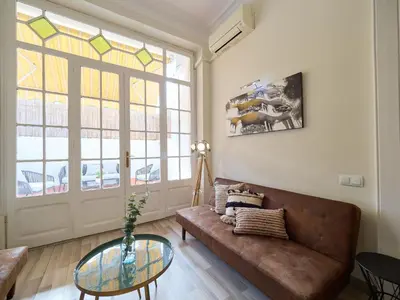 a living room with a couch and a glass table at BarcelonaForRent The Living Terrace in Barcelona