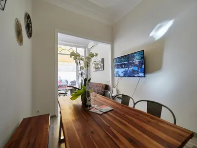 a dining room table with a vase of flowers on it at BarcelonaForRent The Living Terrace in Barcelona