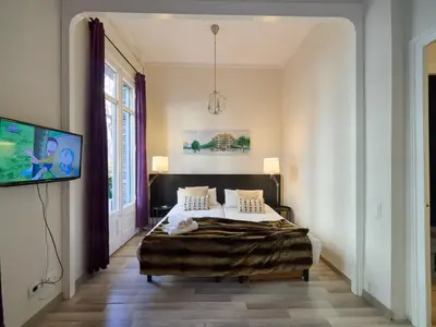 a bedroom with a bed and a tv on a wall at BarcelonaForRent The Living Terrace in Barcelona