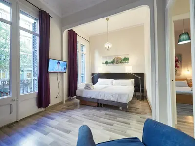 a bedroom with a bed and a tv in it at BarcelonaForRent The Living Terrace in Barcelona