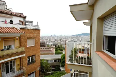 a view of a city from the balcony of a building at Homenfun Barcelona Park Güell in Barcelona