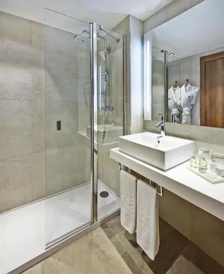 a bathroom with a sink and a shower at NH Barcelona Les Corts in Barcelona