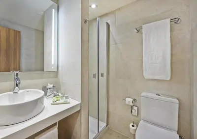 a bathroom with a sink and a toilet and a shower at NH Barcelona Les Corts in Barcelona