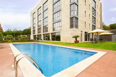 a swimming pool in front of a building at Sercotel Cornellà Barcelona in Cornellà de Llobregat