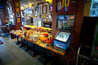 a buffet in a restaurant with a lot of food at Hotel Subur in Sitges