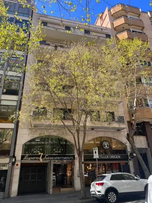 a building with a car parked in front of it at Apartaments-Hotel Hispanos 7 Suiza in Barcelona