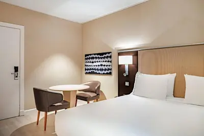 a hotel room with a bed and a table and chairs at AC Hotel Irla by Marriott in Barcelona