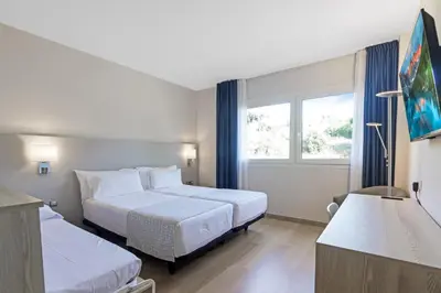 a hotel room with two beds and a window at Augusta Barcelona Vallès in Granollers