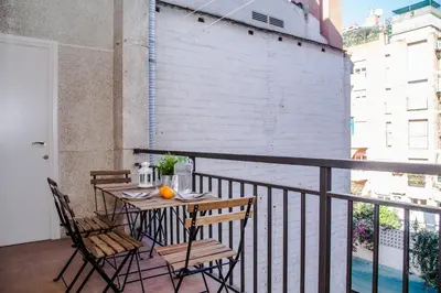 a balcony with a table and chairs on a balcony at BarcelonaForRent Urban Town Suites in Barcelona