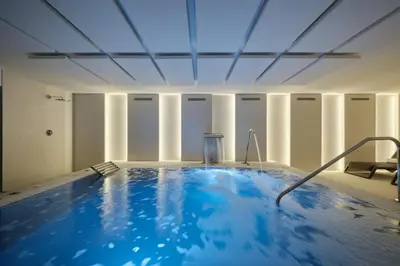 a large blue swimming pool in a building at Catalonia La Maquinista in Barcelona