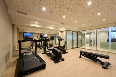 a gym with several treadmills and elliptical machines at Catalonia La Maquinista in Barcelona