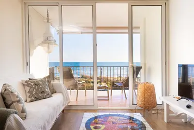 a living room with a view of the ocean at LETS HOLIDAYS Beach front apartment in Gavà Mar, Pine Beach in Gavà